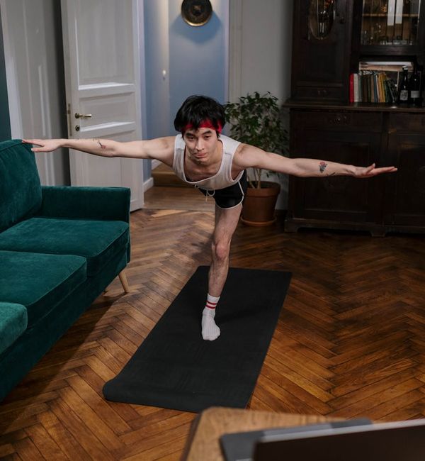 Person holding a challenging yoga pose, demonstrating strength and focus.